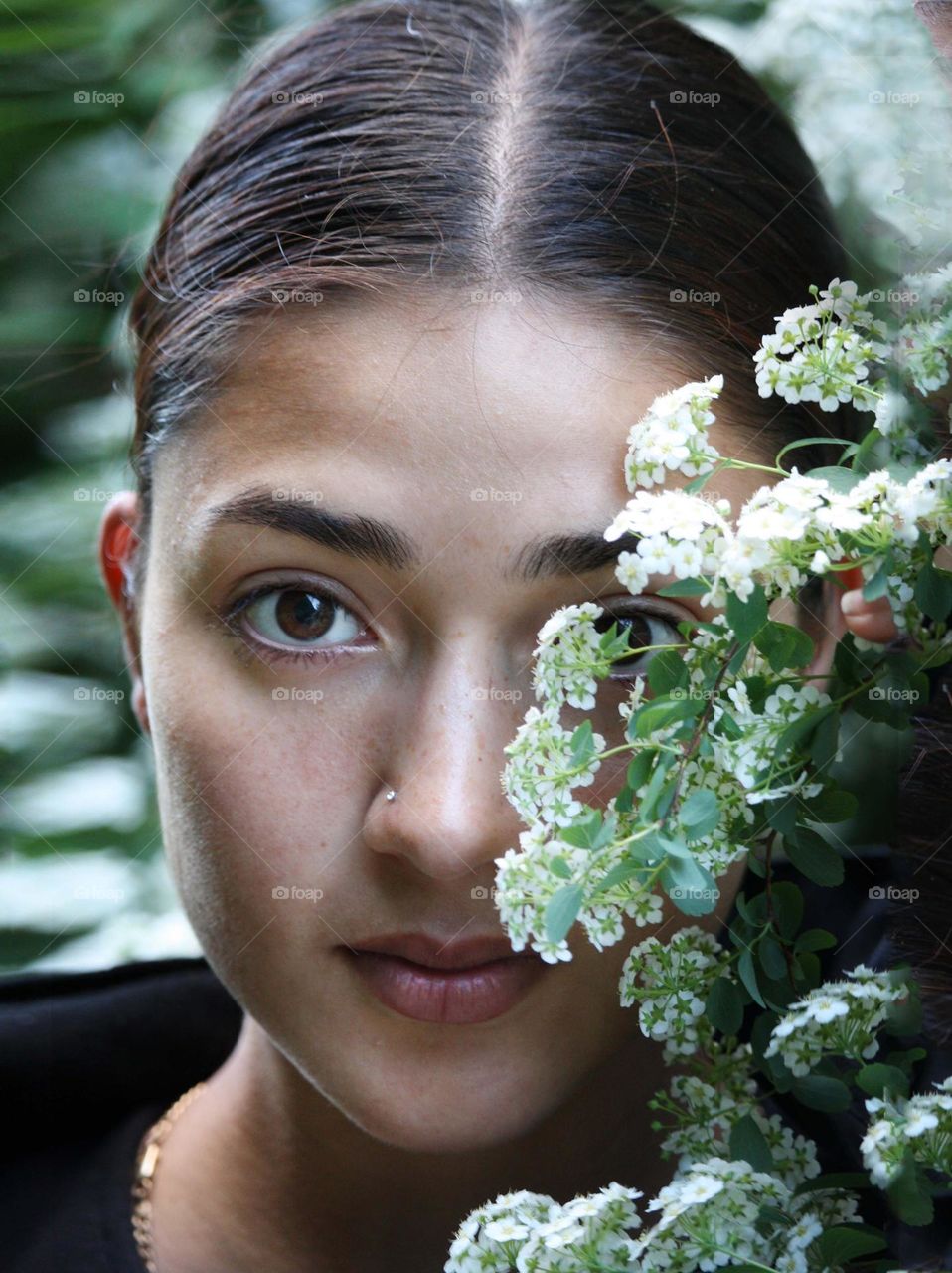 Beautiful young woman with white flowers