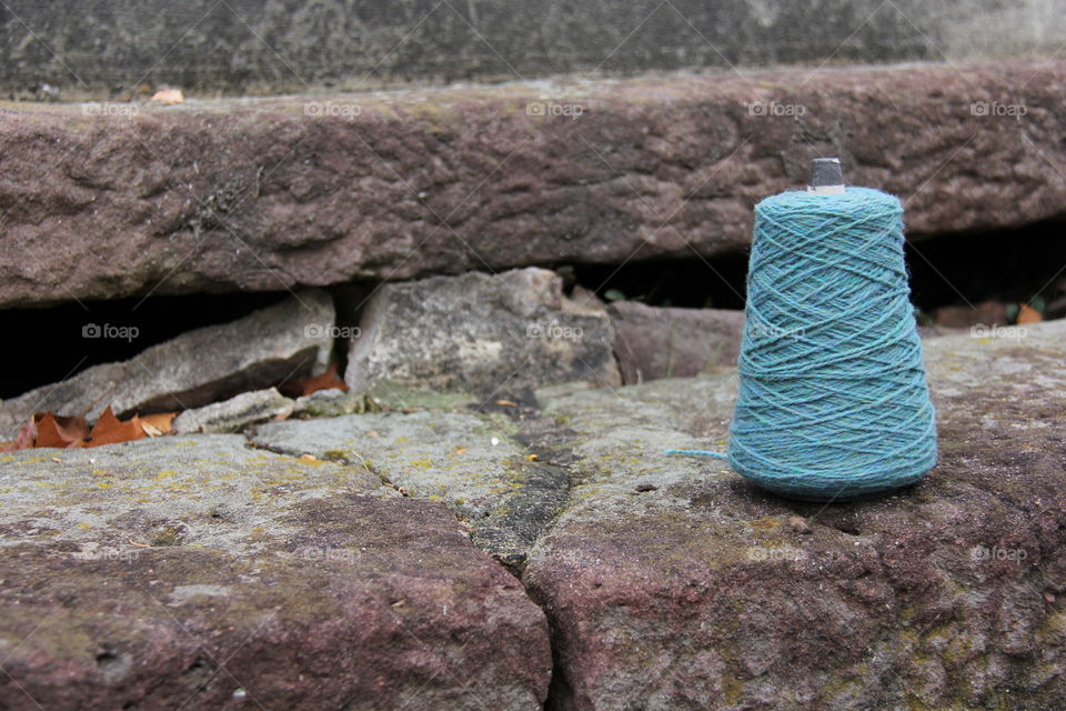 Yarn spool on rock