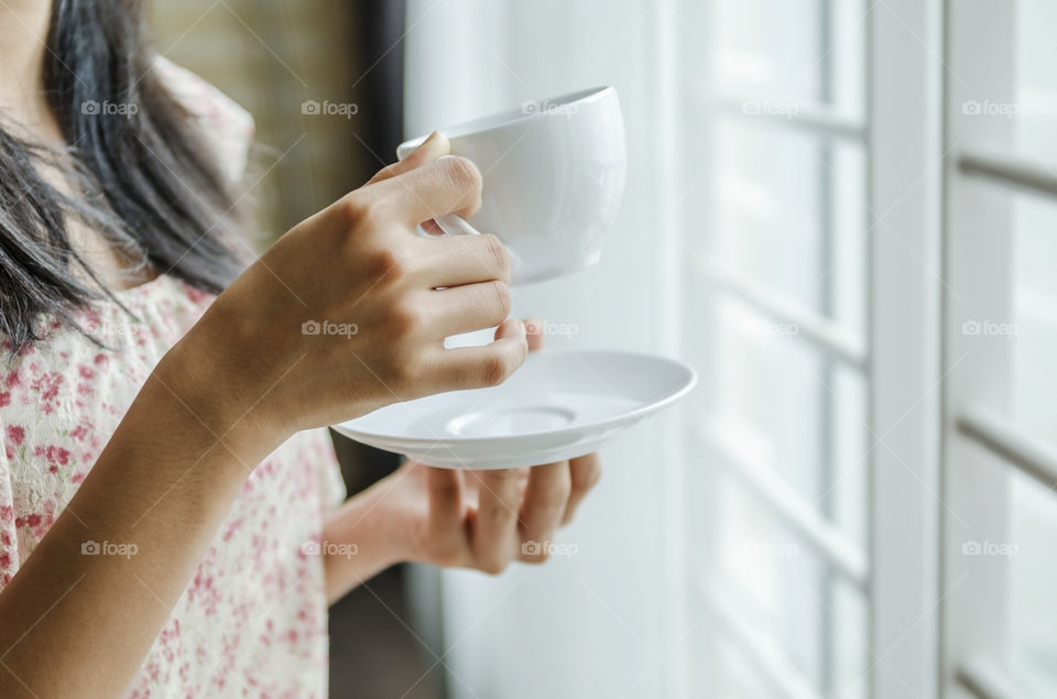 Woman holding a cup of coffee