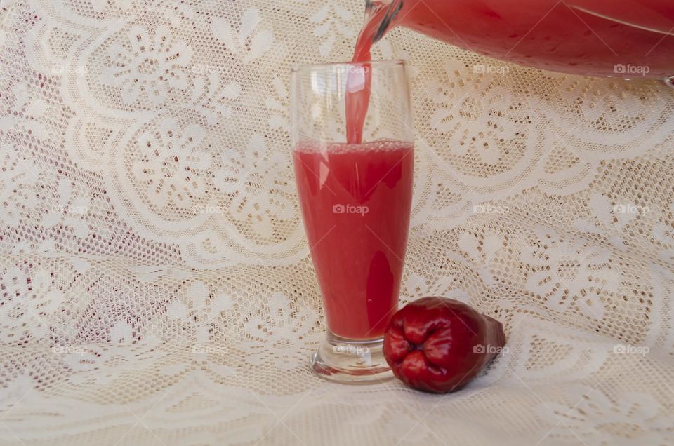 Pouring Otaheite Apple Juice In Drinking Glass