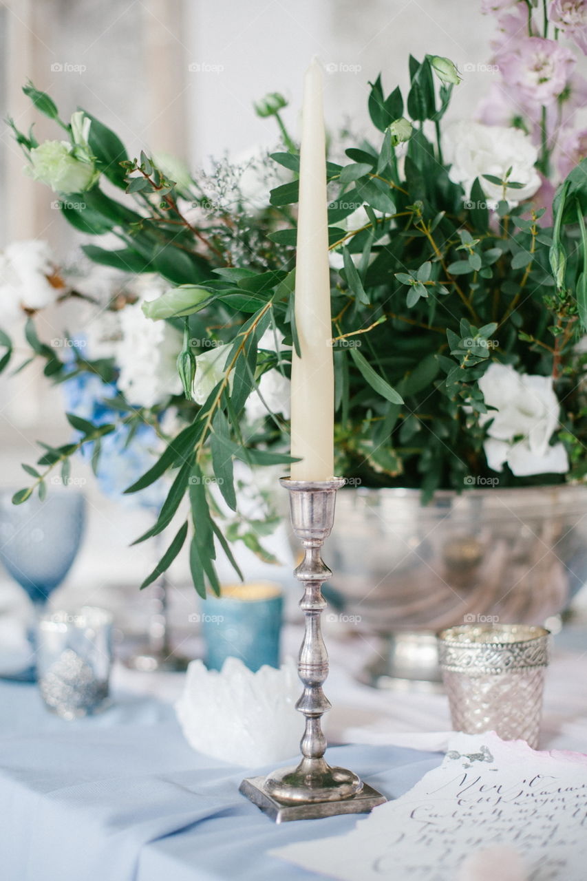 Silver candlestick as element of festive table wedding centerpieces decorations.