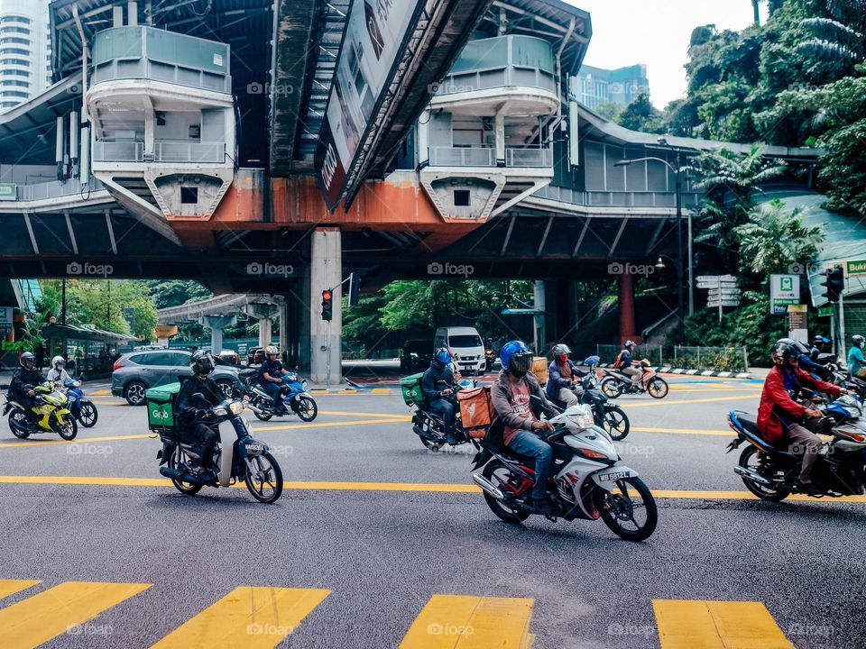 Motorcycles crossing the street junction in Kuala Lumpur