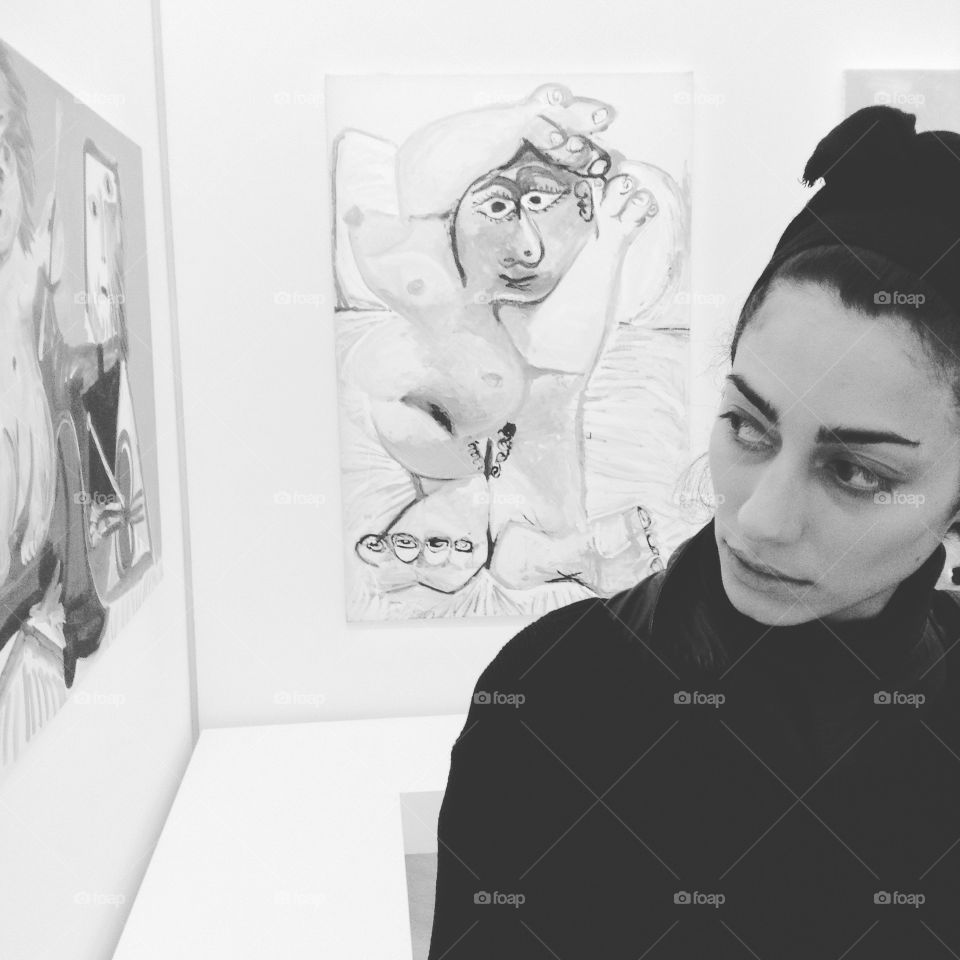 Young woman watching drawing in art gallery