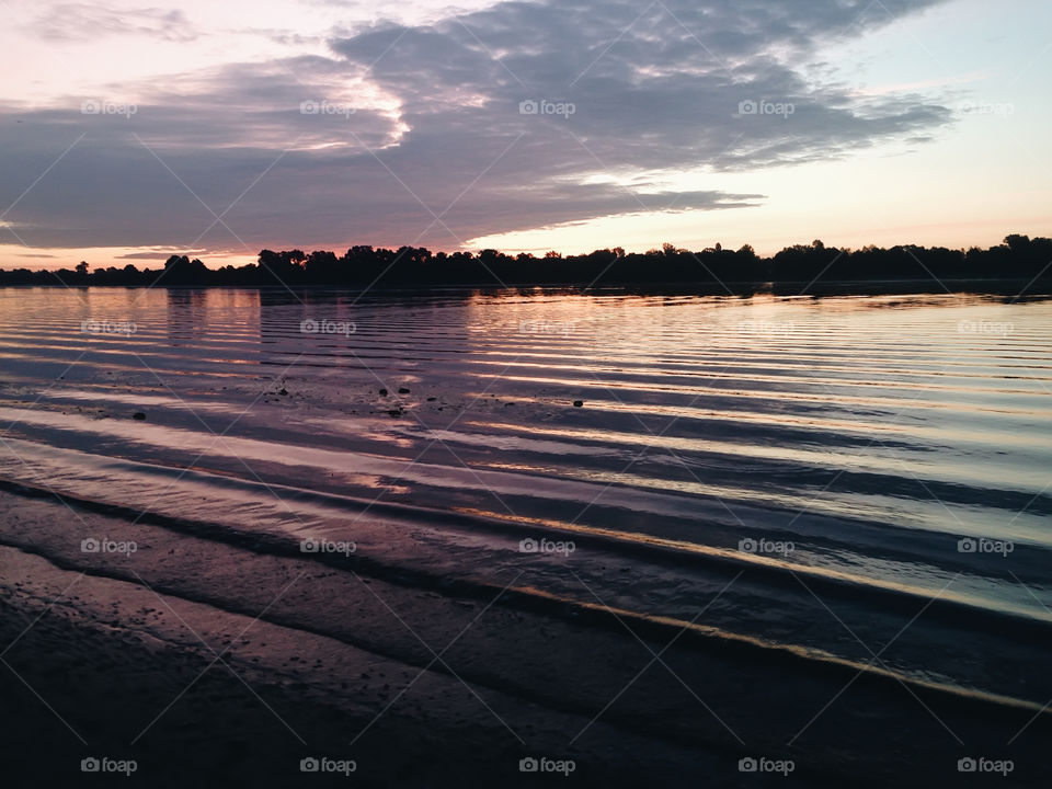 Scenic view of beach at sunset