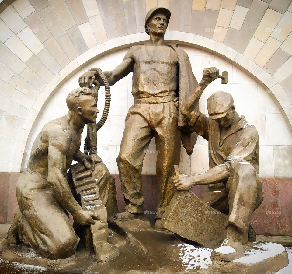 Sculptural group.  Three men.  Monument to the people who built the metro
