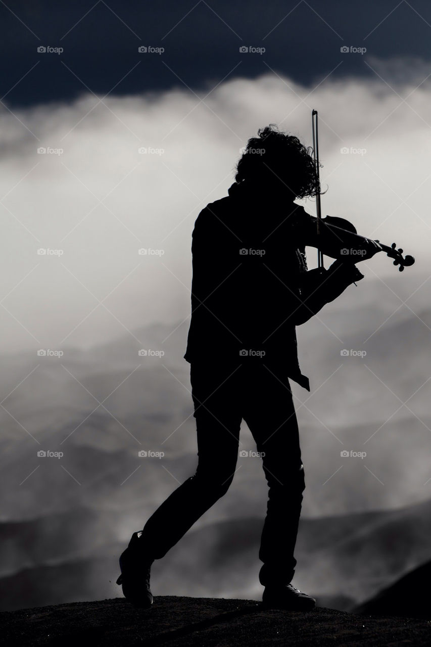 Violinist silhouettes on bromo