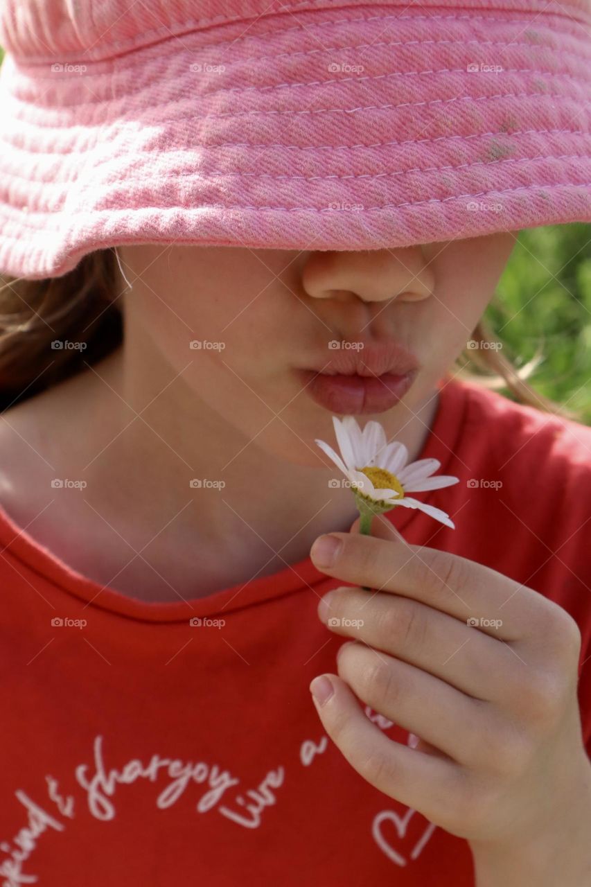 Girl and a flower sunny spring