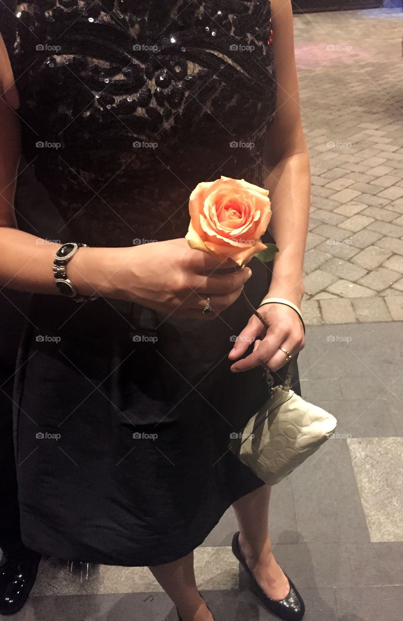 Date Night. A woman holding a rose