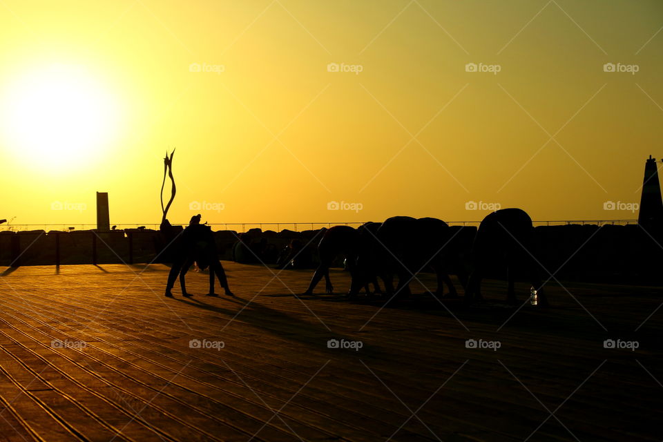 stretching at golden hour. women doing sports in tel aviv at sunset