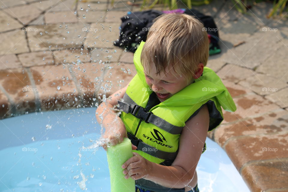 summer fun. Cousin playing in a pool, taken in Toronto