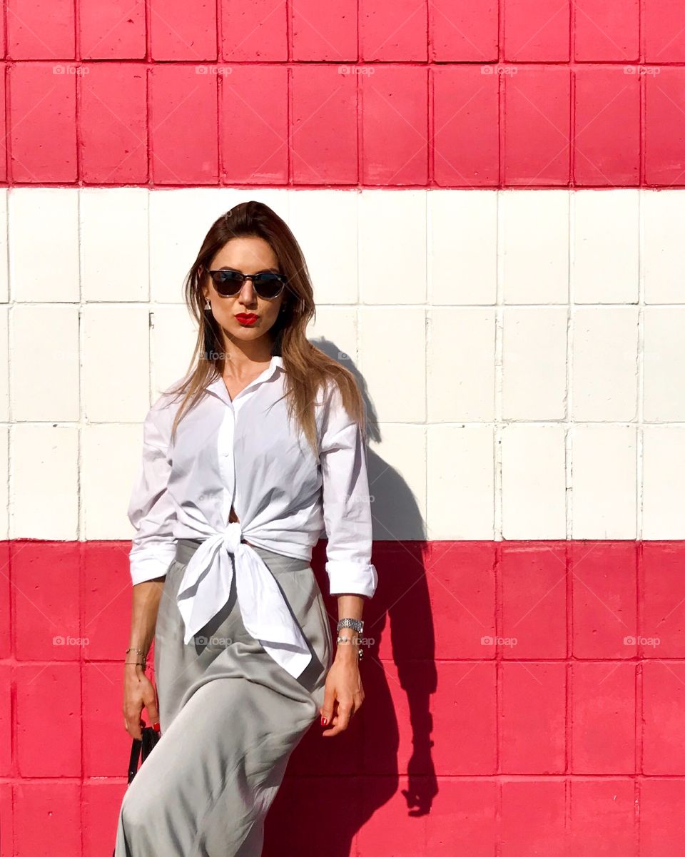 A stylish girl on a red and white background 