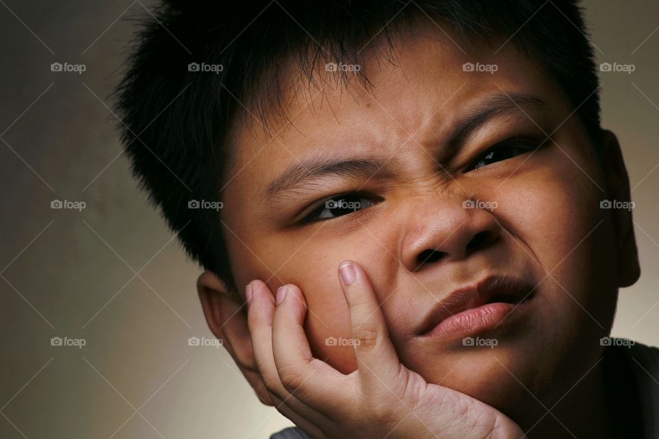 close up photo of a boy with a funny facial expression