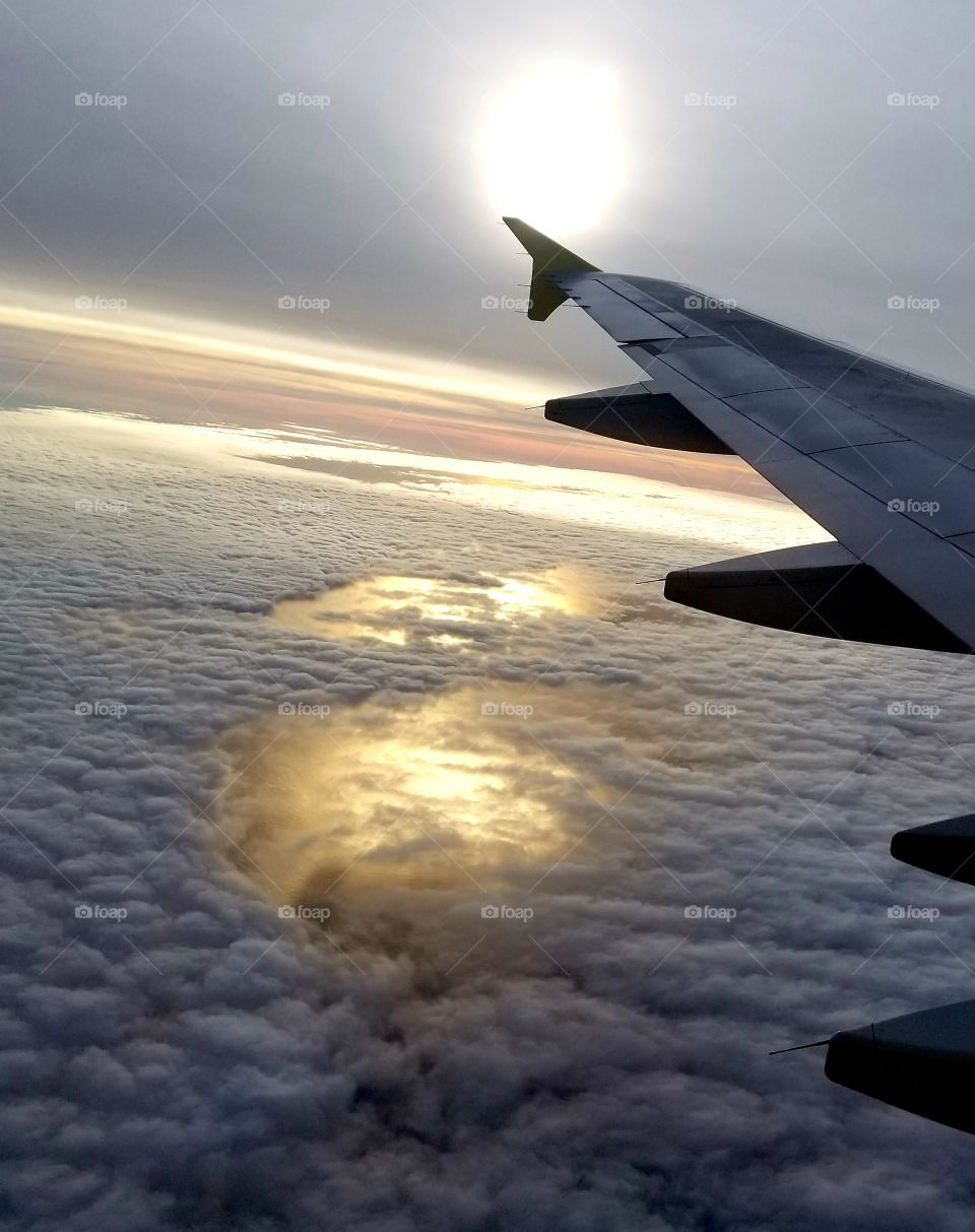 Flying above the snow clouds,  trying to beat the storm