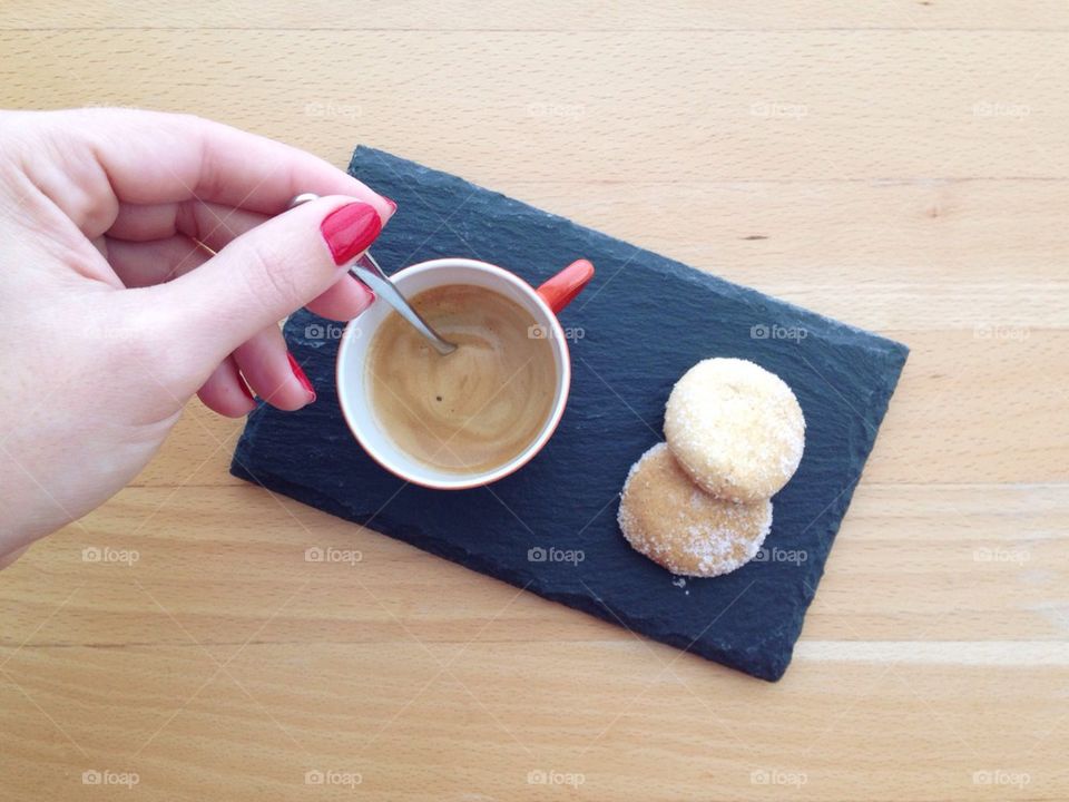 Woman stirring cup of coffee 