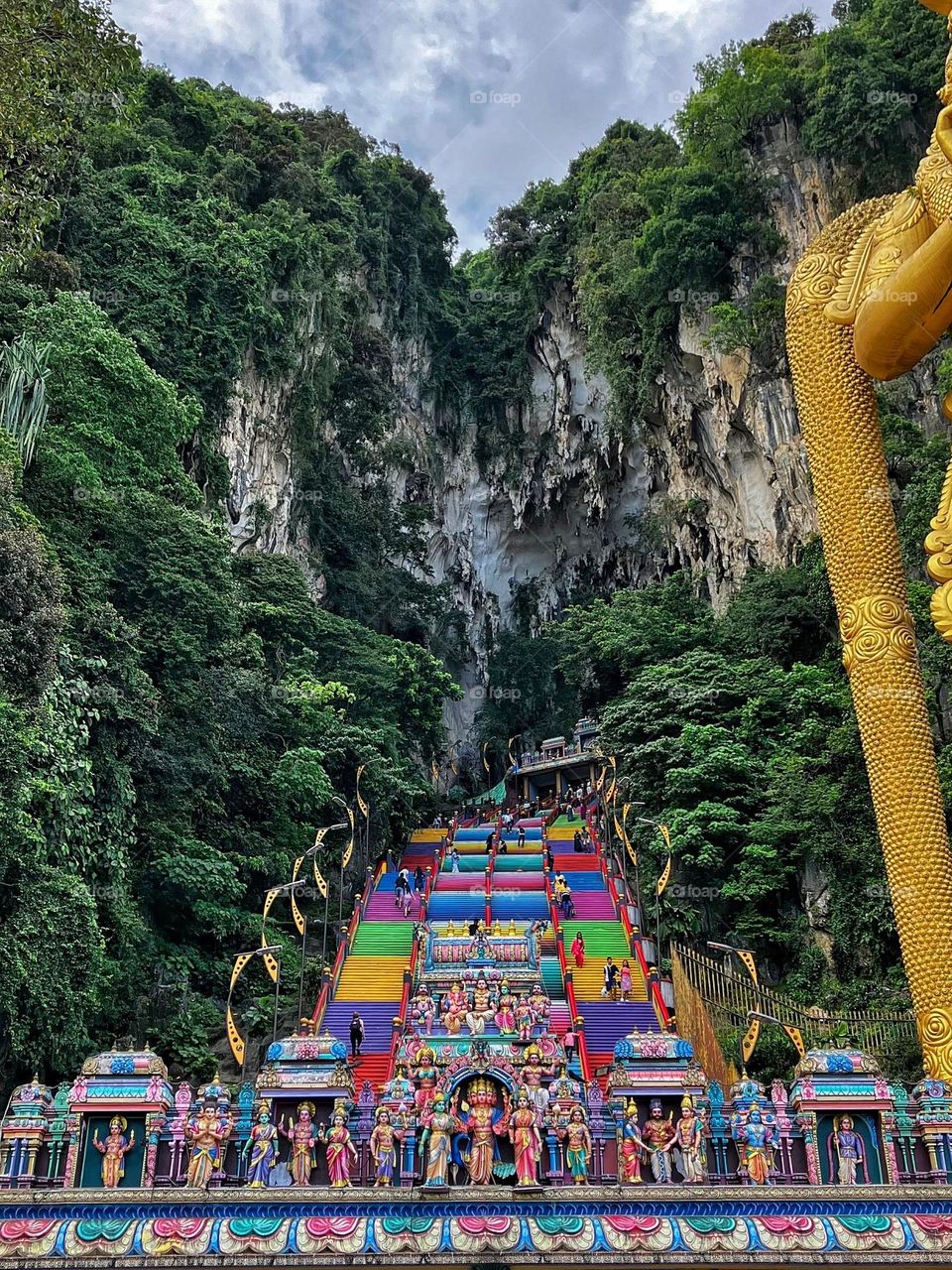 Vibrant and colorful steps ascending towards the top of the Batu Caves near Kuala Lumpur, Malaysia.