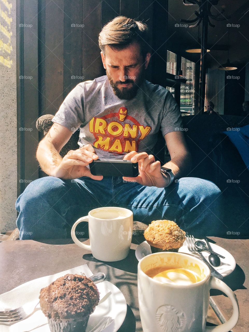 Man taking photo at breakfast