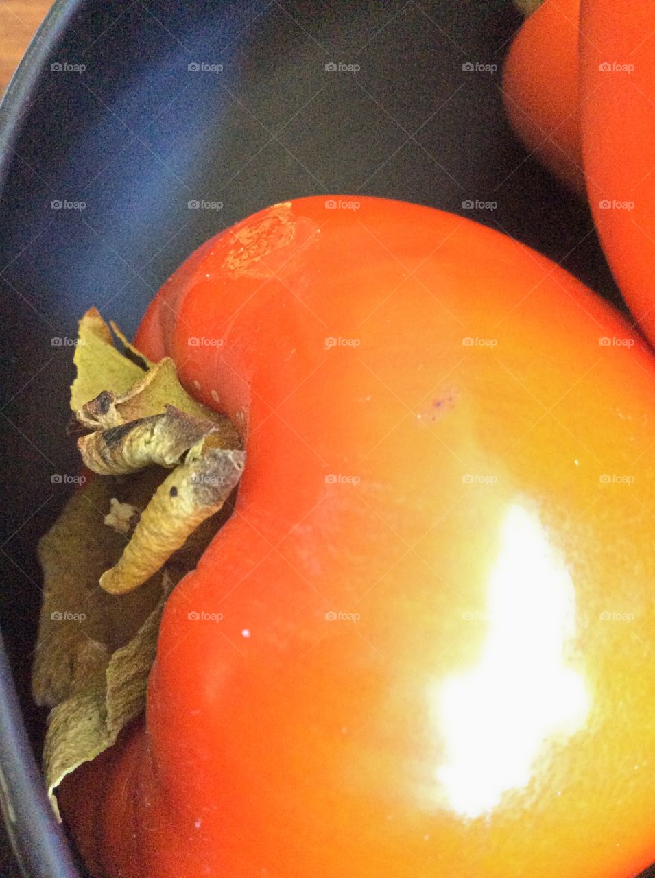 Shiny rounded edge of a persimmon