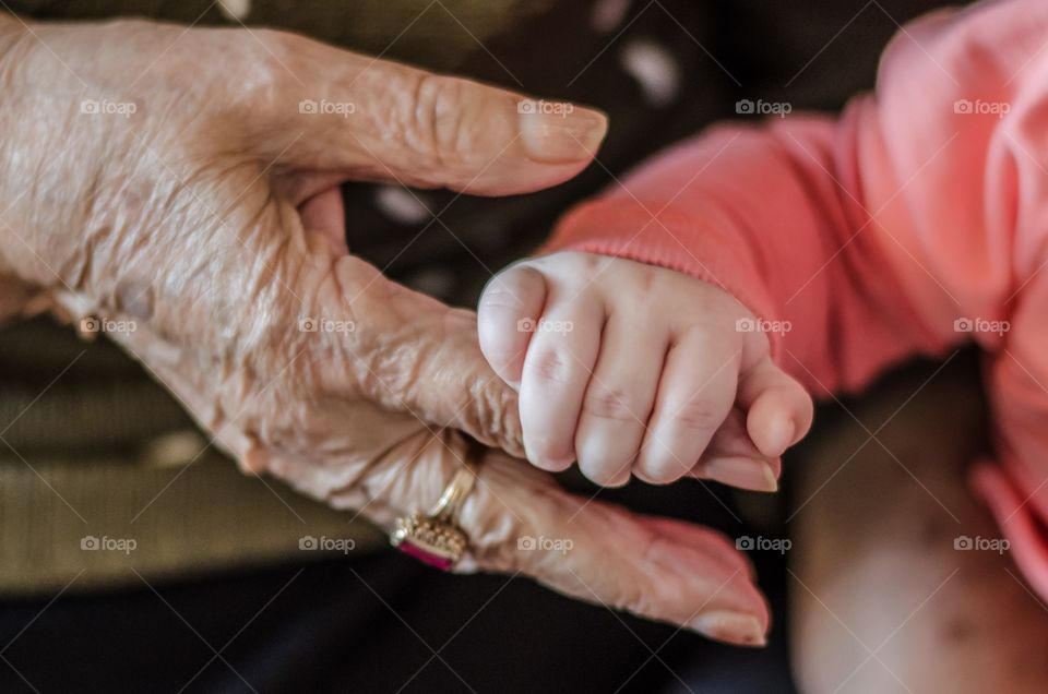 Grandmother and grandchild holding hands