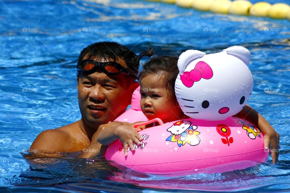 father and daughter in a pool