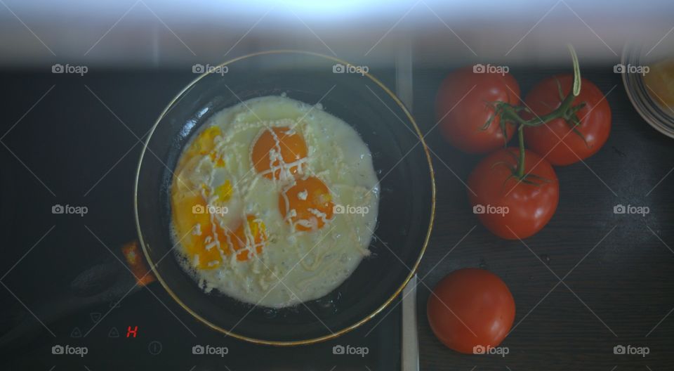 fried eggs with tomatoes breakfast top view background shape