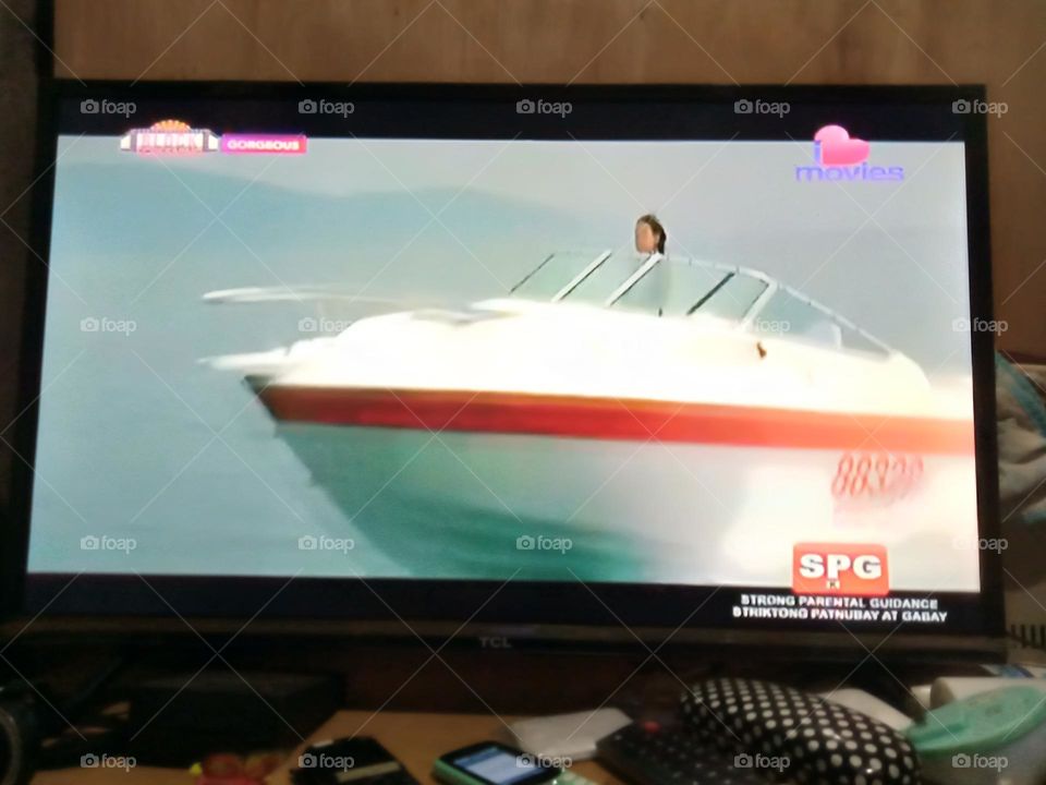 WATCHING MOVIE,, " GORGEOUS " THE LEADING LADY IS DRIVING A SPEED BOAT, TO RESCUE  THE LEADING MAN, JACKIE CHAN