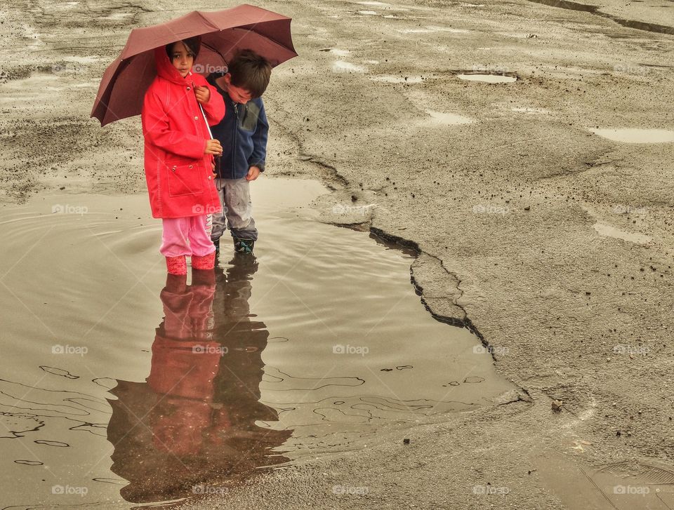 Boy And Girl Under Umbrella