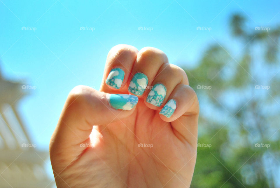 clouds and rain nail art design, against a sky background