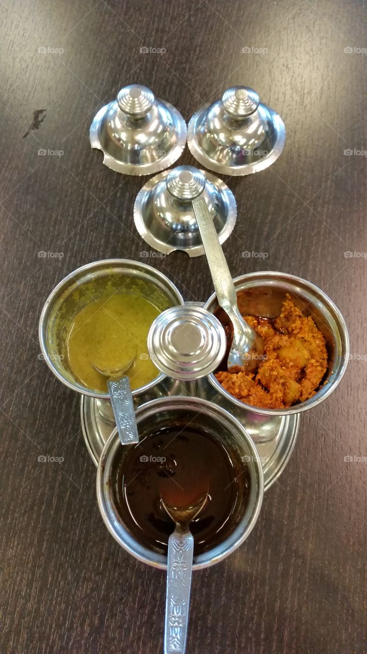 Pickels and chutney in a traditional Indian kitchenware