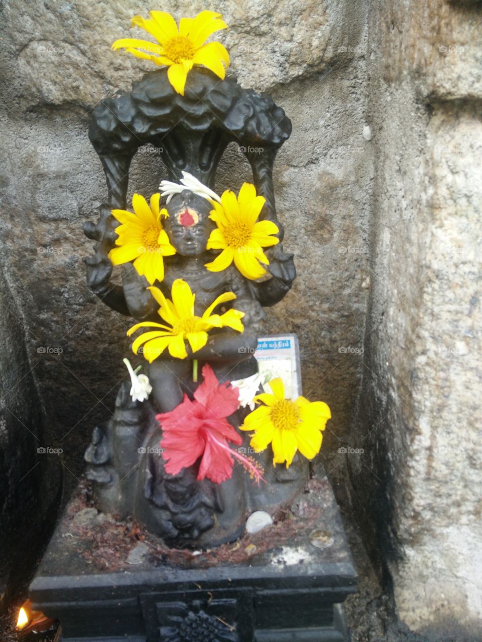 god idol with flowers