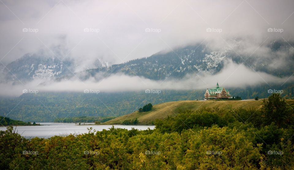 Prince of Wales Hotel in front of low lying clouds obscuring mountains 