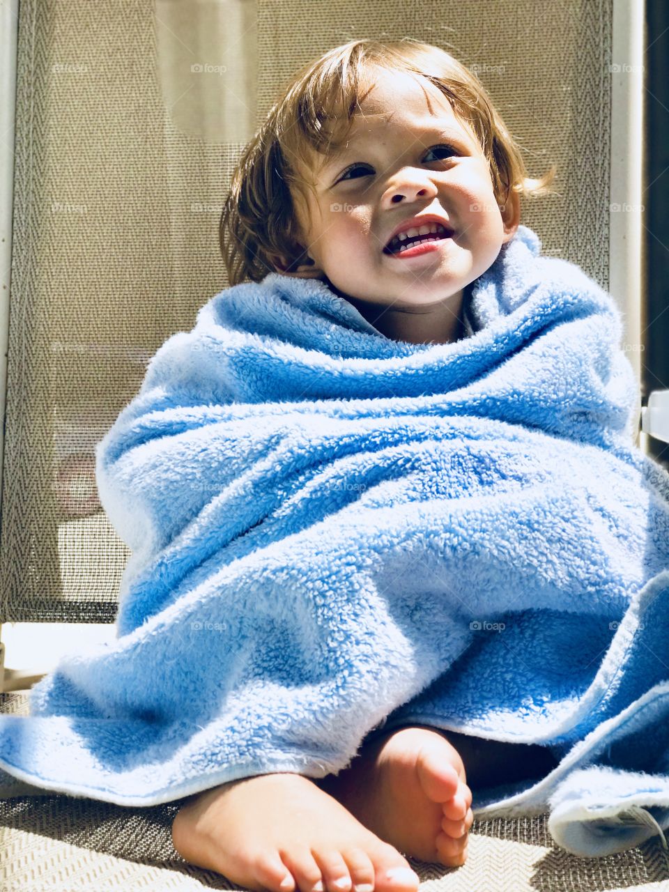 Andrew loves his blue towel, he feels comfortable and cozy with it after deepening himself on the pool. 