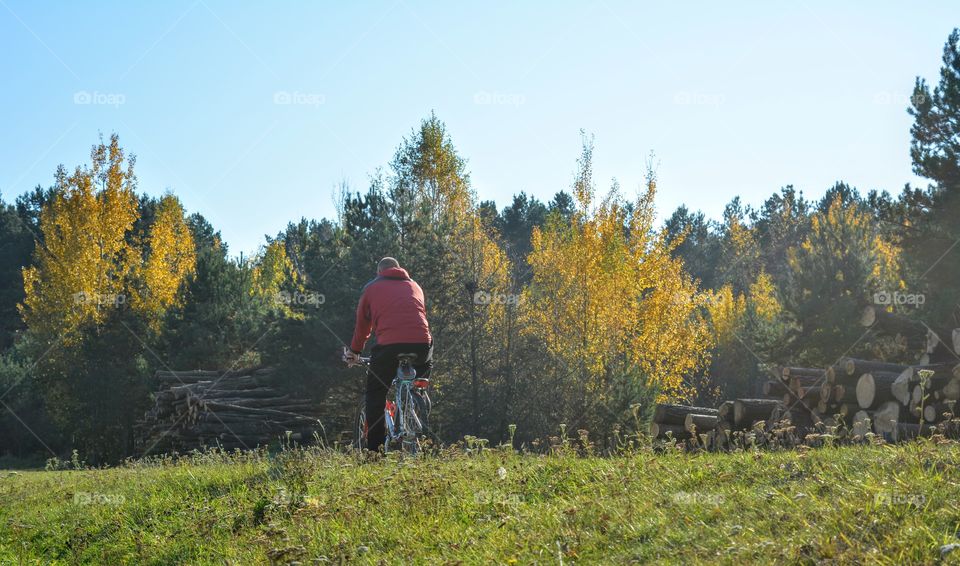 men riding on a bike autumn beautiful landscape