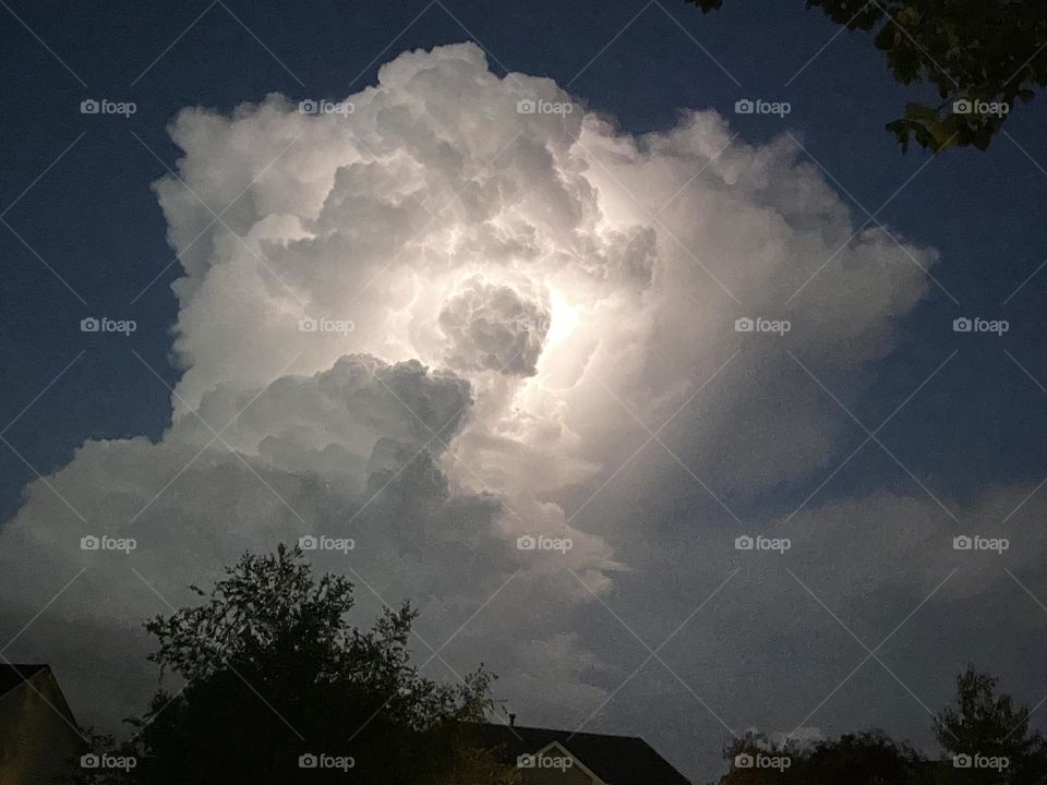 Summer night heat lightning in the cloudy sky