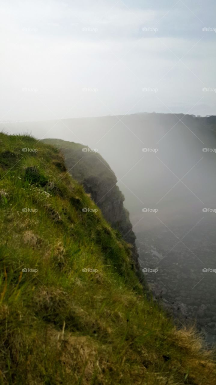 Arbroath cliffs to Auchmithie. Upon walking across the Arbroath cliffs to Auchmithie and Lunan bay I found a crag overlooking the quiet little seafront town. The photo does not do the mist any justice, it was an experience I'd love to share to all!
