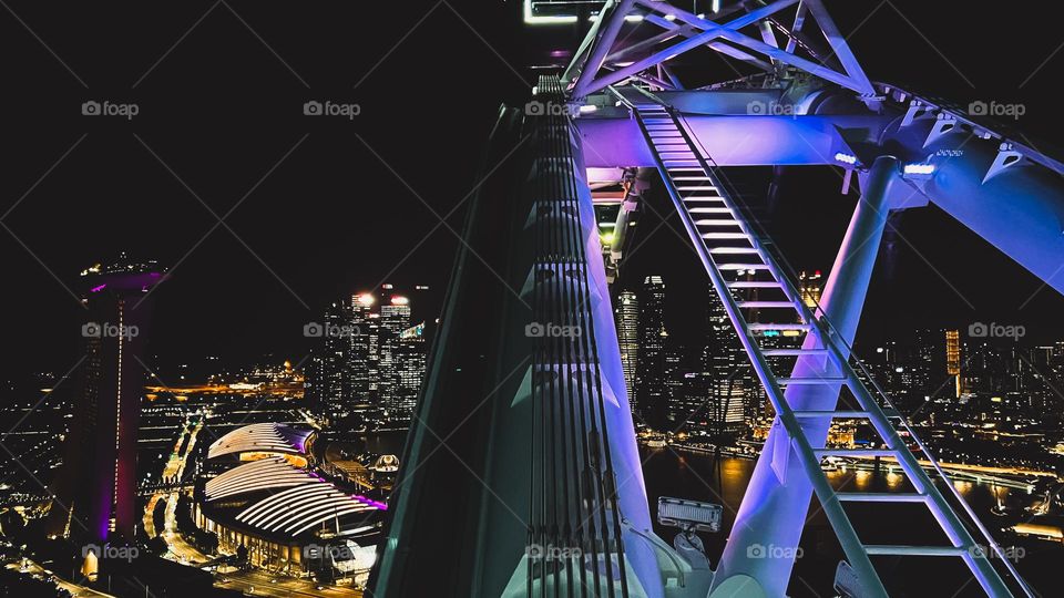 View of Singapore city at night from the deck of the Singapore Flyer.