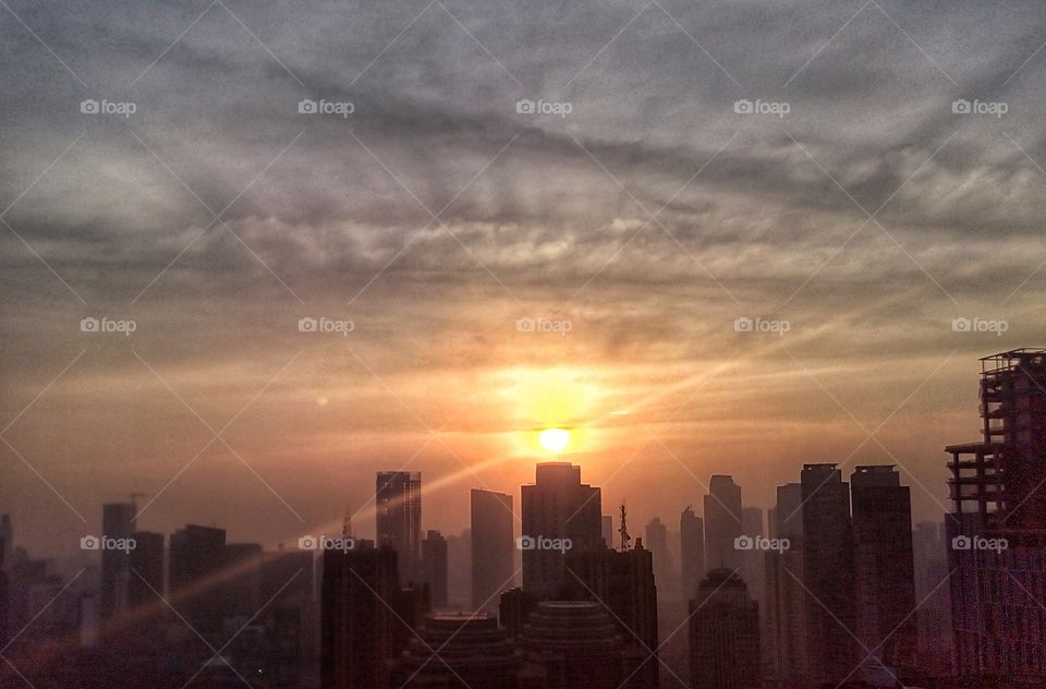 The sun rises over the building