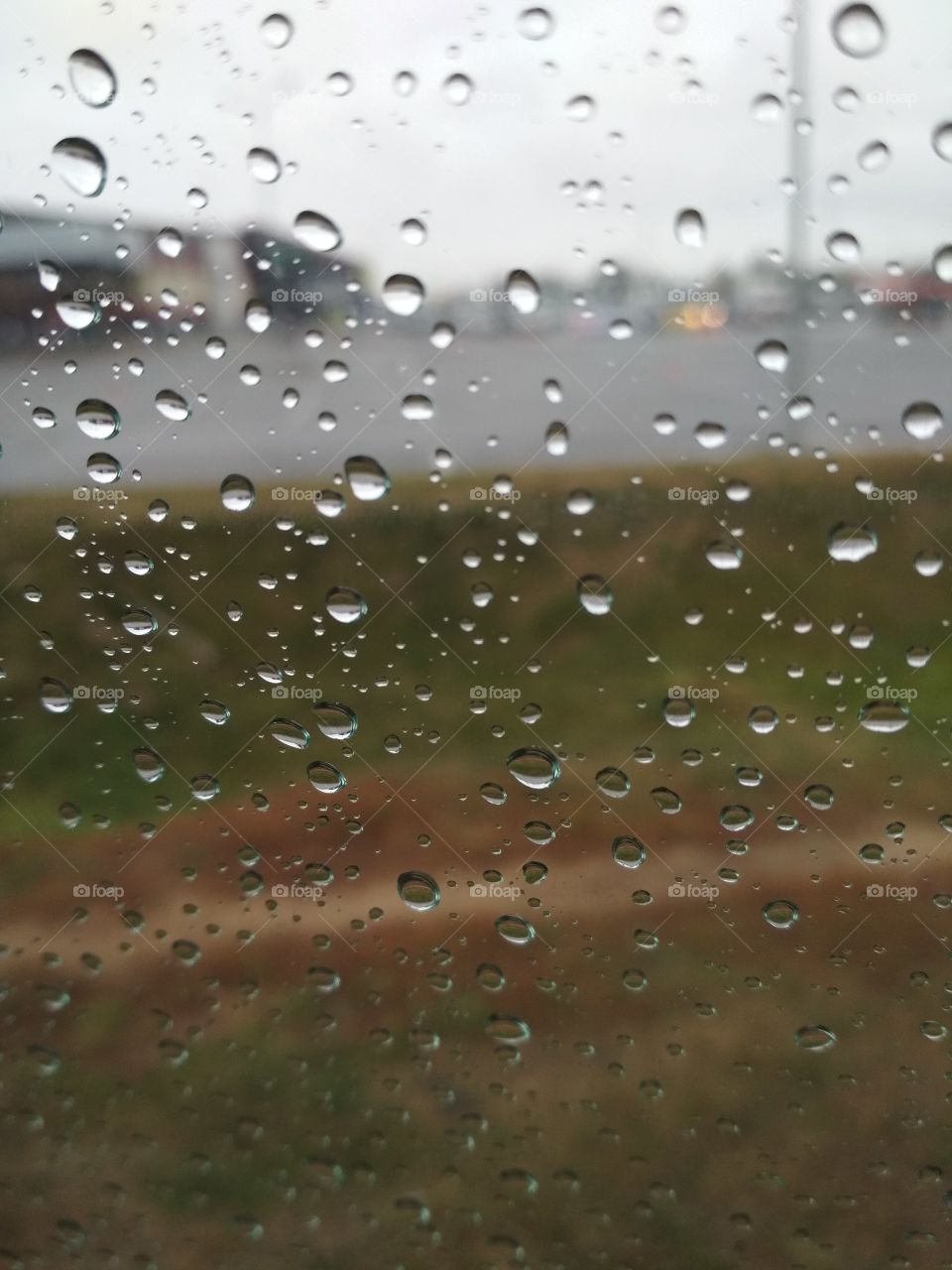 Rain production on the window in the car