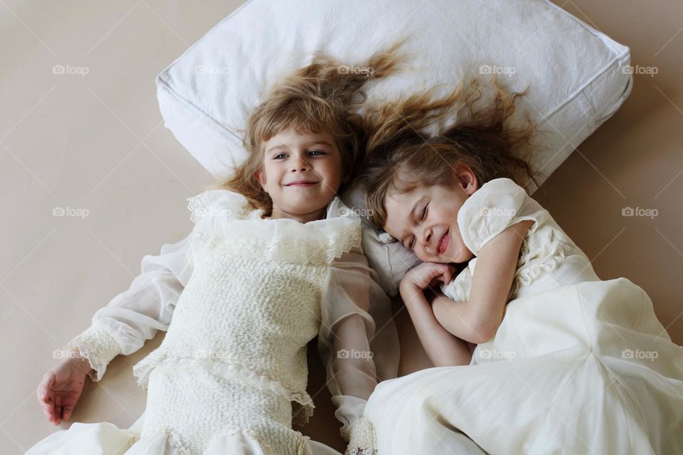 Portrait of cute little twins sisters 