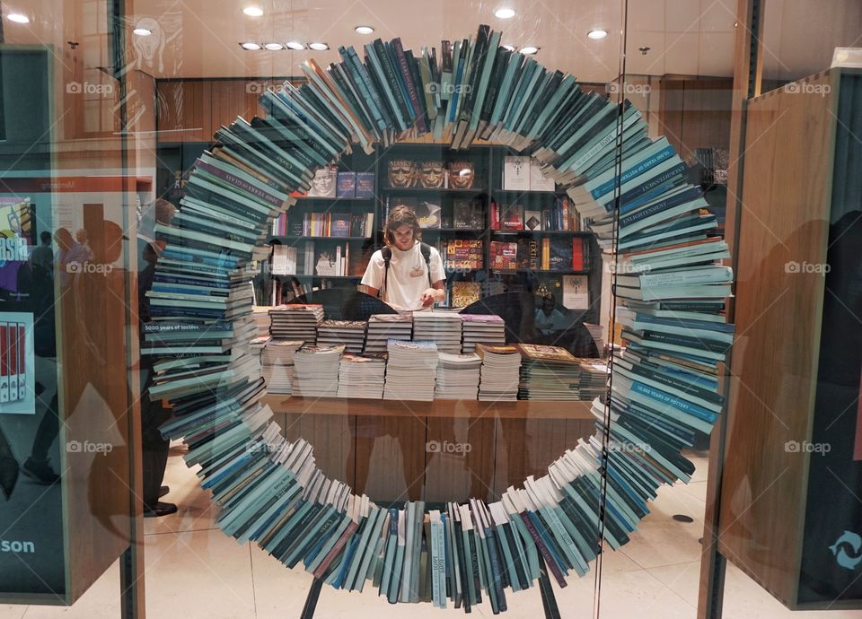 A circle made from books !!! My son in the centre as a second subject but also included in some wording left hand side of the photo .. cropped from Hudson 😂