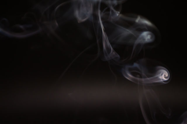 Smoke scented candles on a black background
