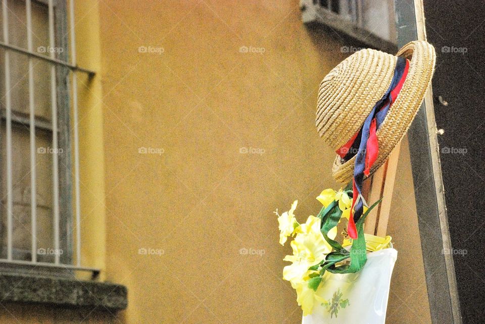 Still life with Hat . I had an flowers perched on out pole in an Italian street