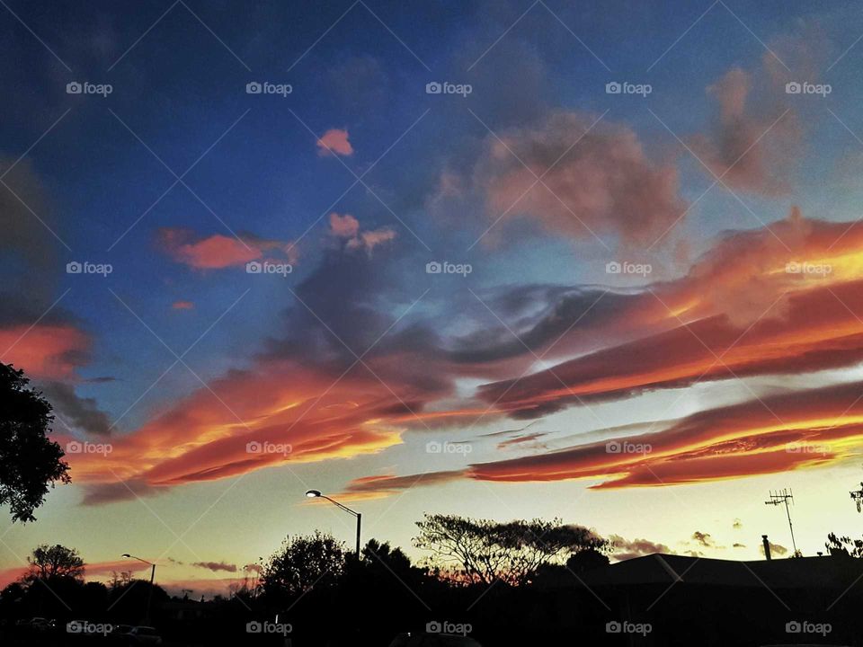 Napier's stunning sunsets scattered color on beautiful cloud formations above the darkened streets.