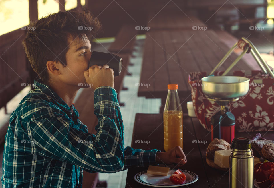 Preparing and eating a breakfast outdoor during spending vacation on camping