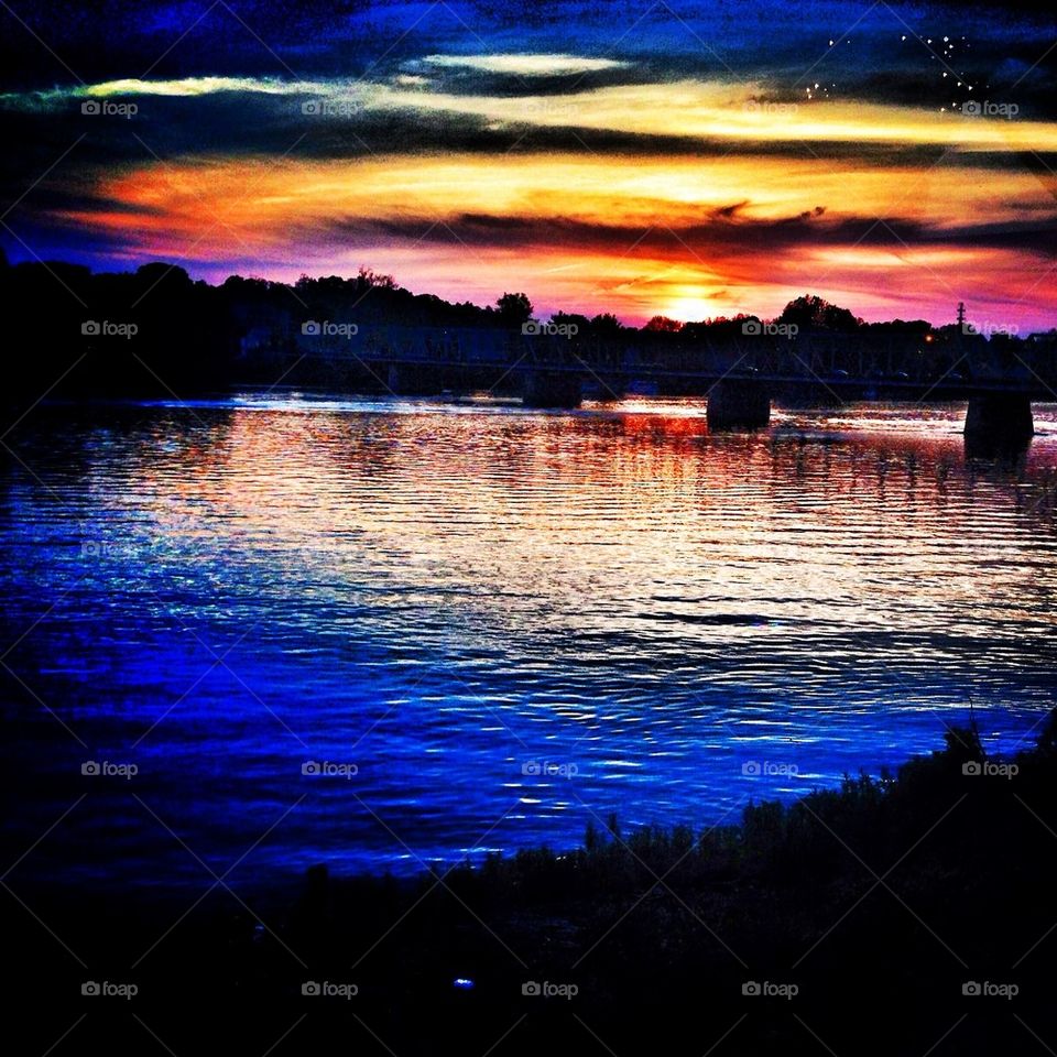 Sunsets along the Delaware river casting vibrant graduations of