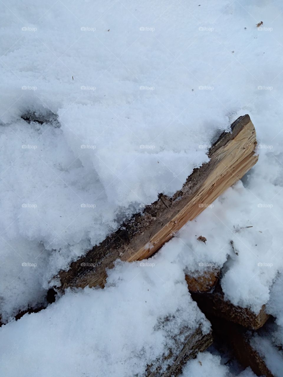 Piece of wood under snow