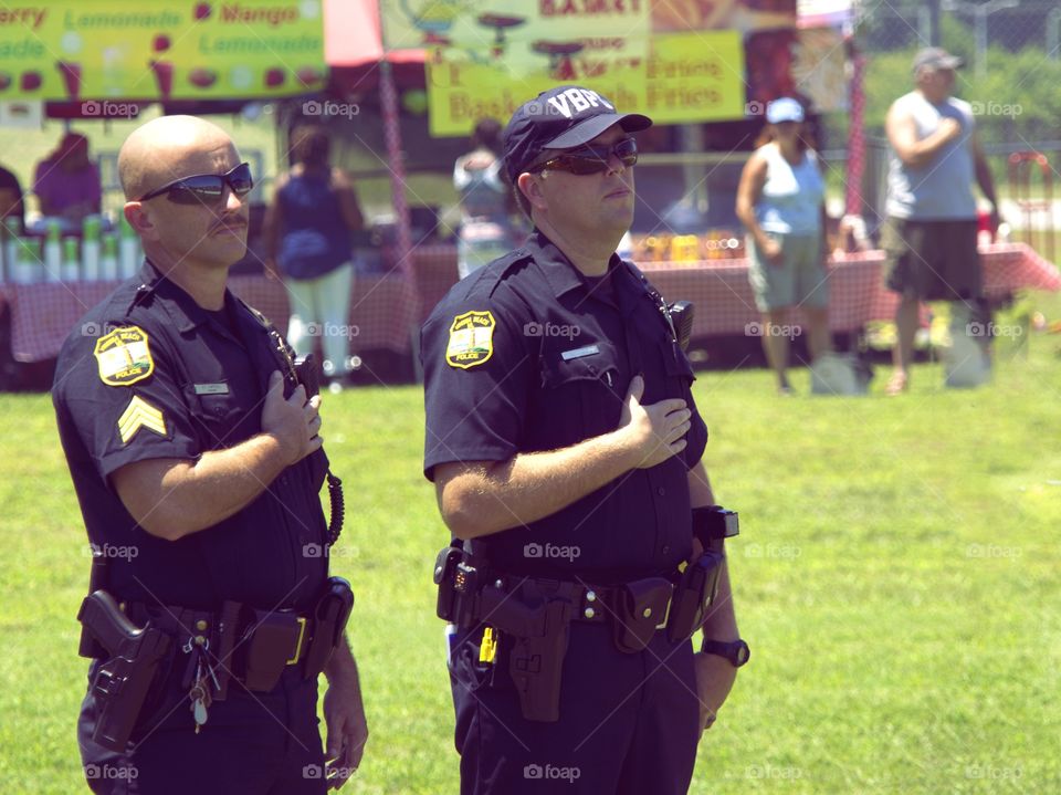 Officer Salute. Police officers show honor during the national anthem. 