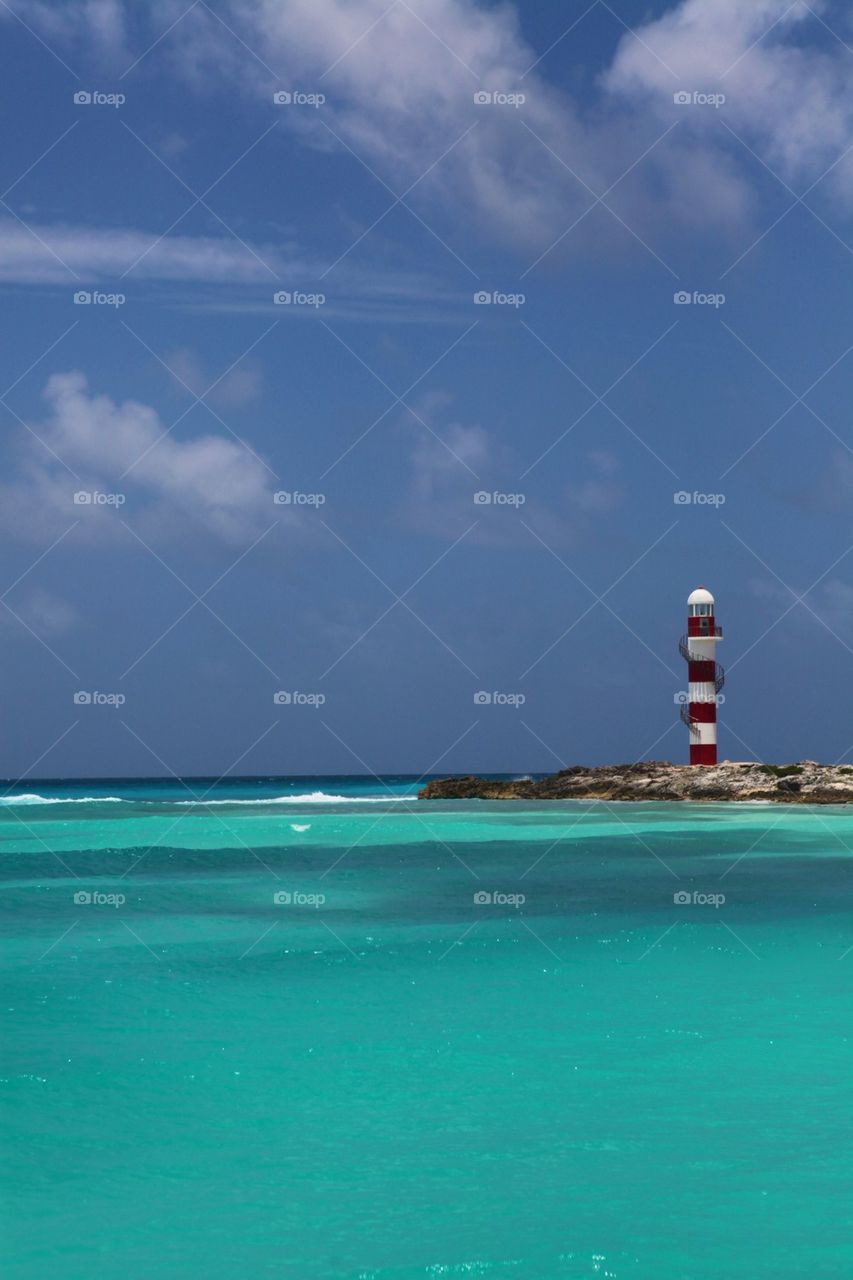 Lighthouse by a caribbean beach