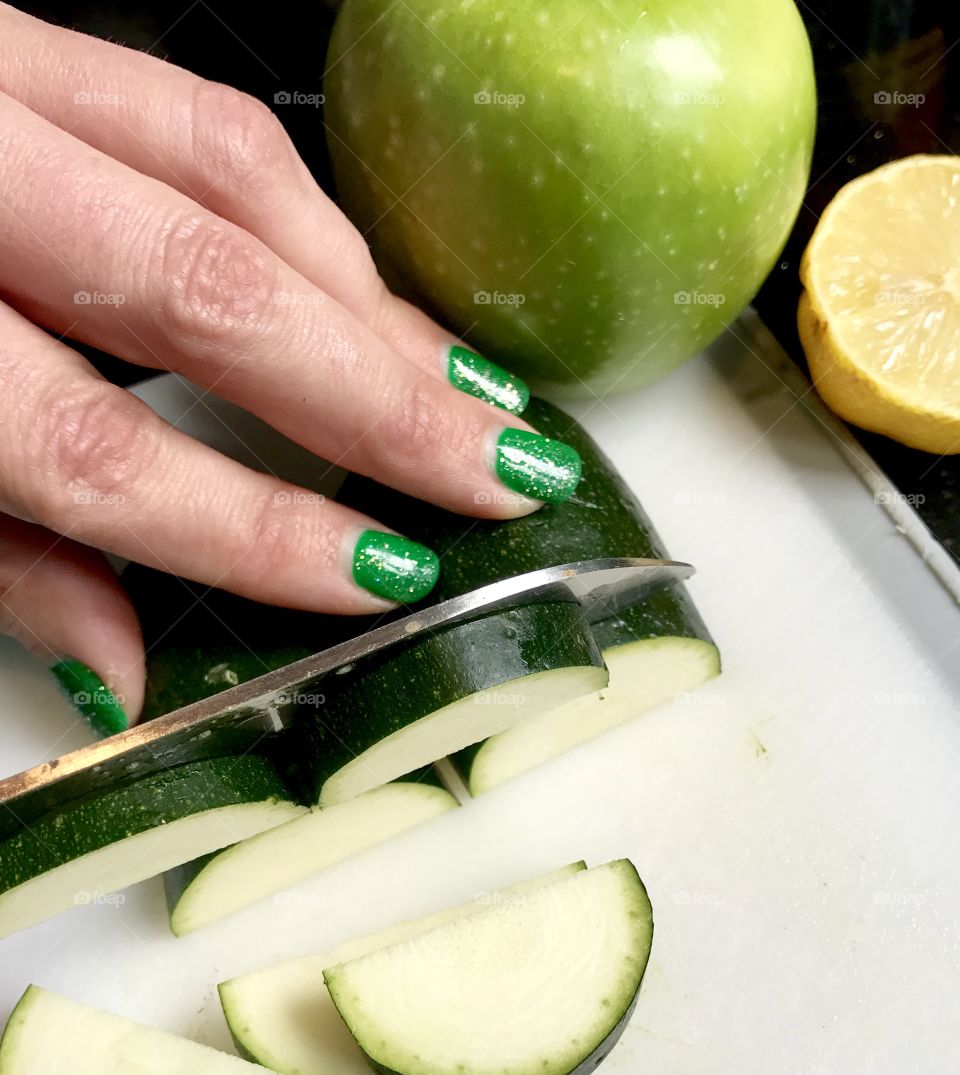 Woman slicing cucumber