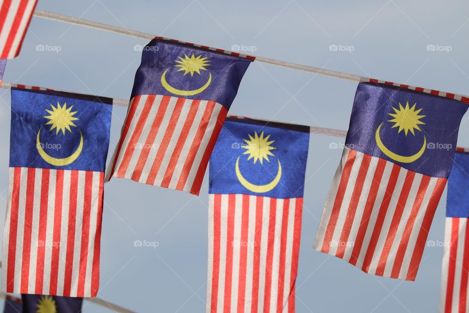 Malaysian flags hanging in the independence day with blue sky background 