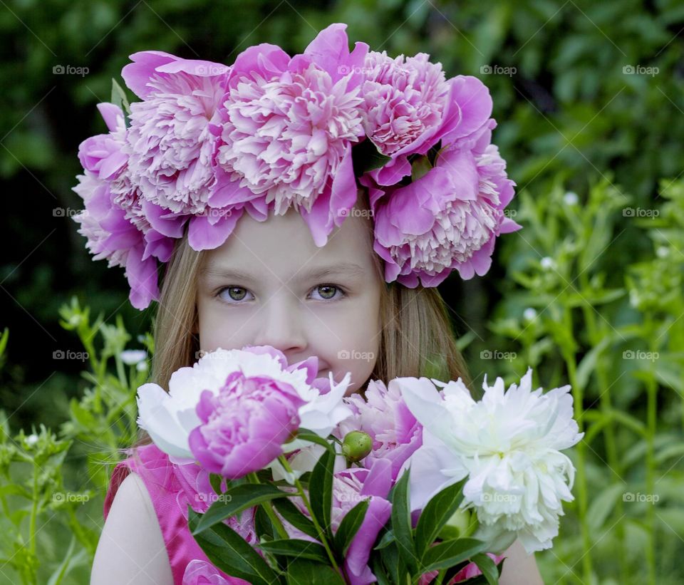 a wreath of peonies on a beautiful girl